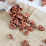 Maple Bourbon Roasted Pecans in a glass jar.