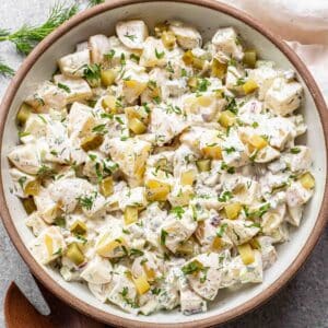 Potato salad in a white serving bowl.