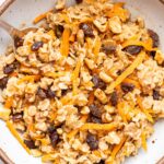 Carrot Cake Oatmeal in a white bowl with a spoon.