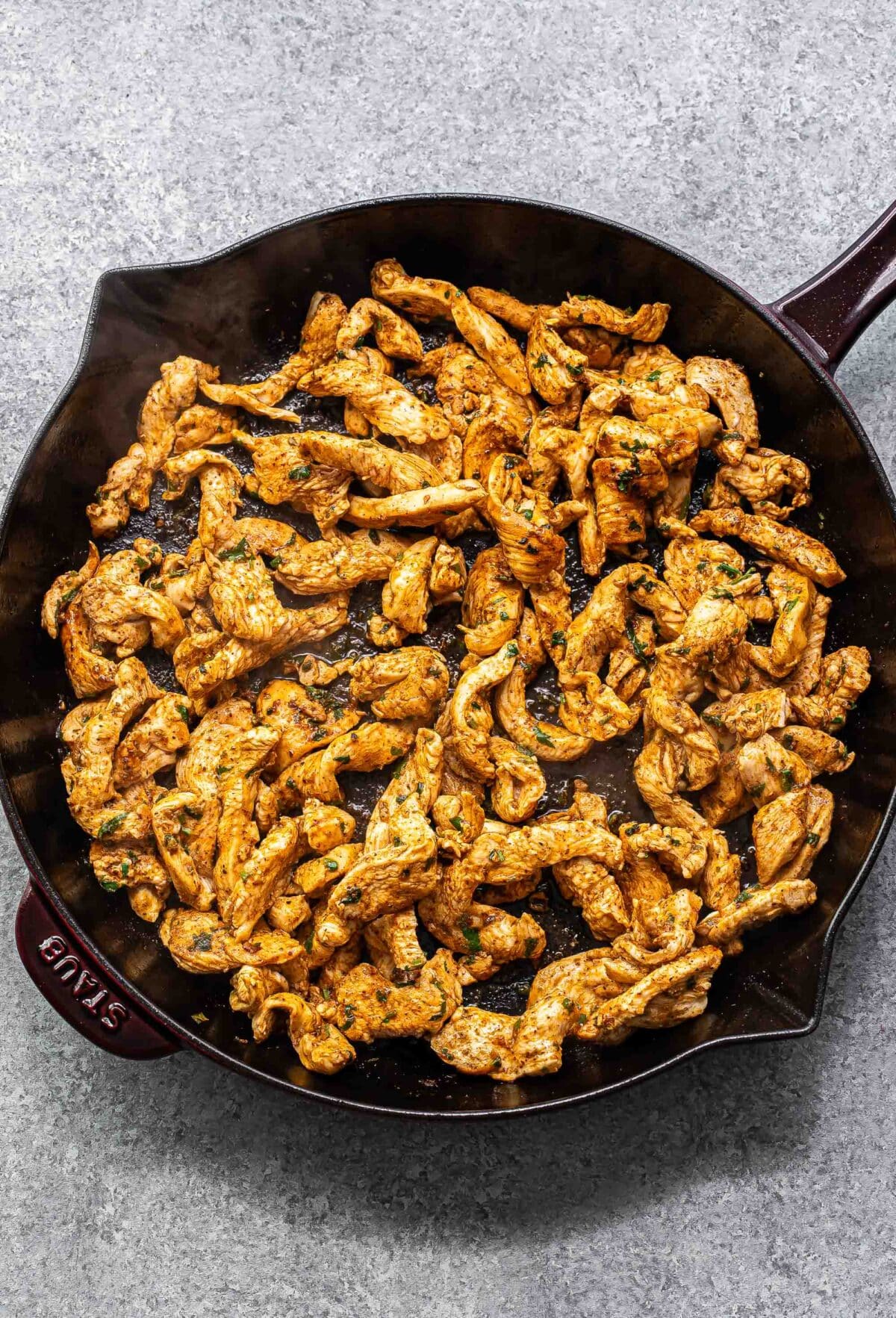 Sautéed chicken for fajitas in a skillet.