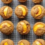 Peach quinoa muffins on a wire cooling rack.