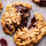 Closeup photo of an Oatmeal Dark Chocolate Cranberry Cookie broken in half.