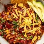 Turkey chili in a white bowl with a spoon.