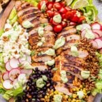 Southwest Chicken Salad with Avocado Lime Dressing on a wooden platter.