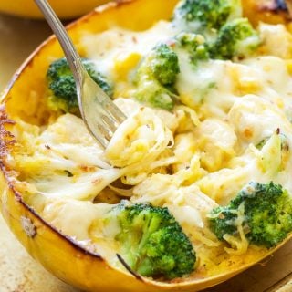Cheesy Chicken and Broccoli Stuffed Spaghetti Squash | Spaghetti squash stuffed with a creamy, cheesy, chicken and broccoli filling and topped with more cheese! A great gluten free, low carb comfort food dinner!