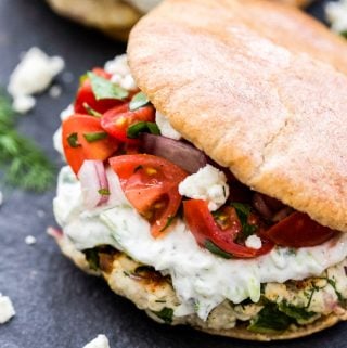 Greek Turkey Burgers with Tzatziki Sauce and Greek Tomato Salad- Juicy turkey burgers topped with cool, creamy tzatziki sauce, feta and a Greek tomato salad for maximum flavor. Serve them in pitas for a fresh and flavorful dinner!