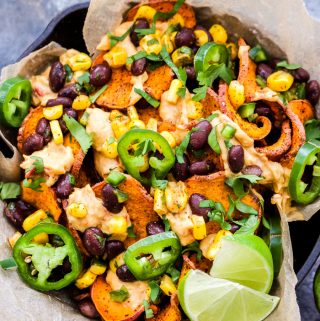 Up your nacho game with these Loaded Southwest Sweet Potato Nachos! Crisp, baked sweet potato rounds piled high with spicy hummus, black bean and corn salsa, cilantro and jalapeños for extra heat. A wholesome, vegan and gluten-free nacho you'll want to dive face first into!