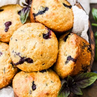Blueberry Basil Cornmeal Muffins are a delicious and healthy breakfast treat! Whole grain, sweetened with honey, loaded with blueberries and the perfect amount of fresh basil for a unique twist!