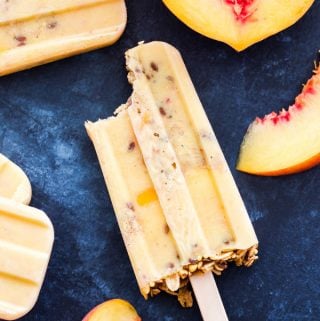 Granola Peach Yogurt Popsicles are perfect for summer snacking! Fresh peaches, Greek yogurt and honey are blended together then combined with layers of granola for the ultimate healthy treat!