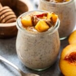 Peach Overnight Oats in a jar topped with diced peaches and almond butter.