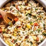 Italian Chicken and Vegetable Skillet with a wooden spoon in the pan.