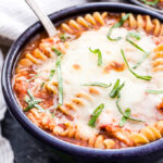 Chicken Parmesan Soup topped with melted mozzarella cheese.