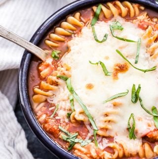 Everything you love about chicken parmesan in a warm bowl of soup! You'll love this easy and comforting Slow Cooker Chicken Parmesan Soup. It's sure to be a family favorite! #soup #glutenfree