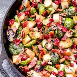 Roasted Brussels Sprouts with Pears, Bacon and Cranberries will be your new favorite holiday side dish! Tons of savory, sweet flavor and it's all made in one skillet! (Gluten-free and Paleo) #brusselssprouts #pears #cranberries #sidedish #thanksgiving #christmas #fallrecipe #glutenfree #paleo #skillet
