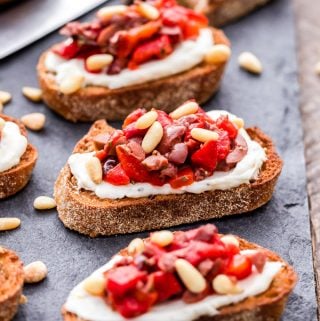 Every party needs a crostini and these Roasted Red Pepper, Olive and Ricotta Crostini deliver major flavor! briny olives, sweet roasted red peppers and creamy ricotta are a perfect pairing in these little bites.