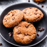 Gingerbread Chocolate Chip Almond Butter Cookies on a black plate.