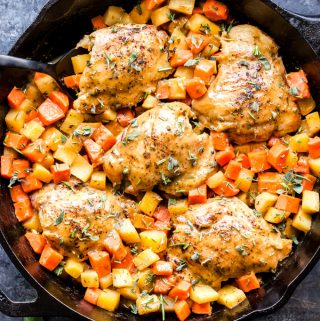 Apricot Chicken Thighs with Root Vegetables is a hearty and easy to make one skillet dinner. Savory with a hint of sweetness from the apricot jam, it's healthy comfort food at it's finest! #chicken #skilletdinner #carrots #apricot #easyrecipe #chickenthighs #glutenfree