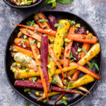 Fragrant, sweet, warmly spiced Garam Masala and Honey Roasted Carrots are the perfect side dish to serve with dinner. Topped with chopped pistachios and fresh mint, they're sure to be your new favorite way to eat carrots! #carrots #garammasala #sidedish #glutenfree #healthyrecipe #paleo #honey