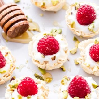 These Honey Goat Cheese and Raspberry Phyllo Cups are perfectly portioned and couldn't be easier to make! A delicious, no-fuss dessert that's perfect for Valentine's Day! #dessert #easyrecipe #goatcheese #raspberries #honey #healthydessert #appetizer