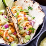 Shrimp Tacos with Avocado Salsa Verde make for an easy and healthy Mexican dinner! Pan seared shrimp topped with the most addictive salsa you'll ever eat and all on the table in 30 minutes! #tacos #shrimp #avocado #salsaverde #glutenfree