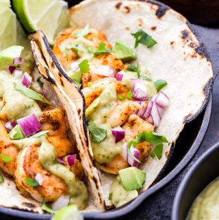 Shrimp Tacos with Avocado Salsa Verde make for an easy and healthy Mexican dinner! Pan seared shrimp topped with the most addictive salsa you'll ever eat and all on the table in 30 minutes! #tacos #shrimp #avocado #salsaverde #glutenfree