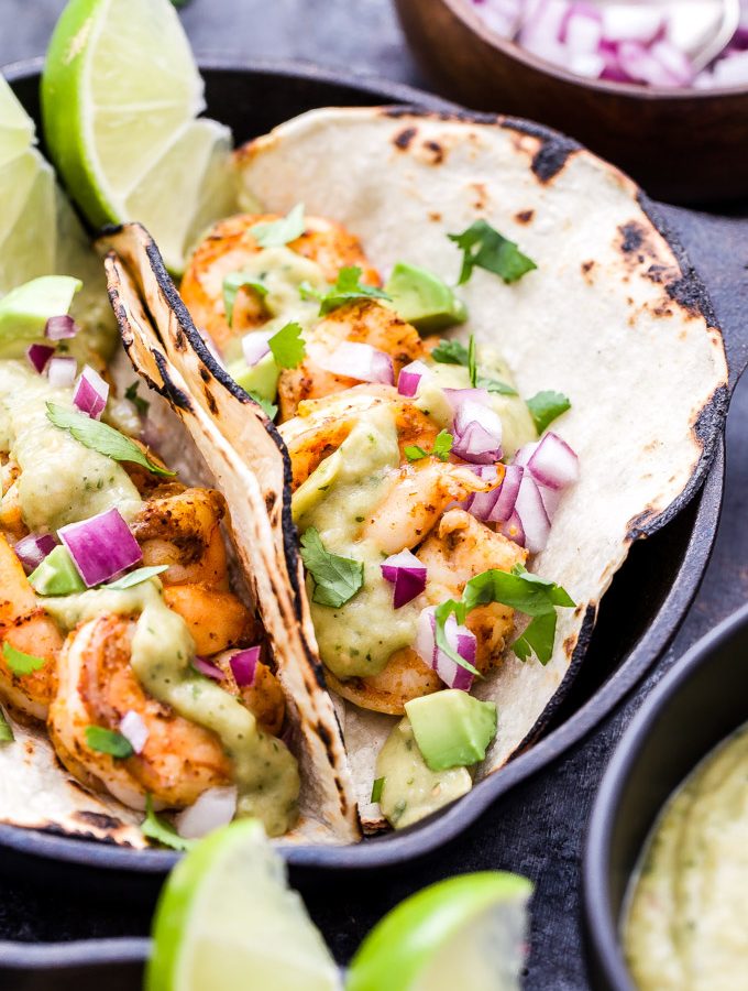 Shrimp Tacos with Avocado Salsa Verde make for an easy and healthy Mexican dinner! Pan seared shrimp topped with the most addictive salsa you'll ever eat and all on the table in 30 minutes! #tacos #shrimp #avocado #salsaverde #glutenfree