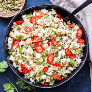 This Andalucían Cauliflower Rice Salad Bowl is a low carb, grain-free version of the traditional Spanish rice salad. Full of healthy fats, salty, briny flavors and no cooking required! #lowcarb #cauliflowerrice #salad #grainfree