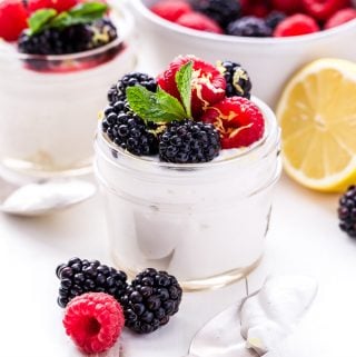 Berry Lemon Whipped Yogurt Parfaits are the perfect lighter dessert to make this spring! Greek yogurt, whipping cream and lemon are whipped together and topped with lightly sweetened berries. Creamy and sweet without being over the top! #berries #lemon #greekyogurt #parfait #dessert
