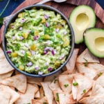 Green Chile Guacamole is the perfect way to add a little heat and smoky flavor to traditional guacamole. Serve with chips, on tacos or any of your favorite Mexican dishes! #guacamole #greenchile #dip #mexicanfood #avocados