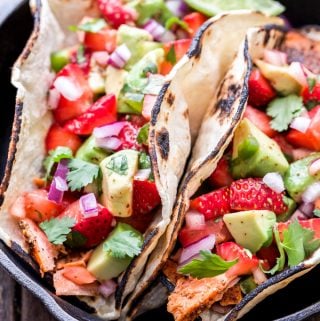 Grilled Salmon Tacos with Strawberry Avocado Salsa will be a hit this grilling season! Mexican spiced grilled salmon topped with the most flavorful sweet, savory and spicy salsa. Tacos you can feel good about eating! #tacos #salmon #strawberries #avocado #salsa #grilling #glutenfree