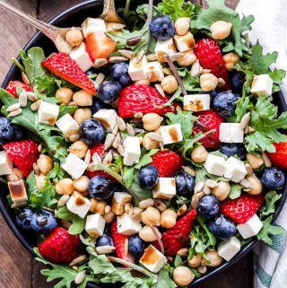 Berry, Chickpea, Feta Salad with Honey Balsamic Vinaigrette is perfect for spring and summer! Bursting with fresh berries, salty feta, chickpeas, crunchy sunflower seeds and a fabulous honey balsamic vinaigrette. An easy, delicious and beautiful salad that's sure to become a new favorite! #salad #strawberries #blueberries #feta #chickpeas #vegetarian