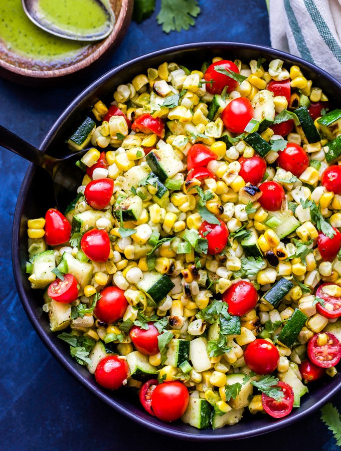 Grilled Zucchini Corn Tomato Salad is a simple salad using all of summer's finest produce. Grilling the vegetables adds a wonderful smoky flavor and the cilantro lime vinaigrette brings the whole salad together! #salad #corn #zucchini #tomatoes #grilling #glutenfree #vegan