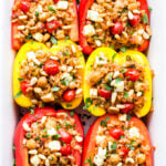 Mediterranean Stuffed Peppers in white casserole dish