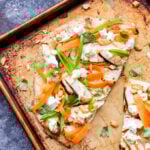 Tandoori Chicken Naan Flatbread is perfect for dinner or an appetizer. Flavorful, grilled, Indian spiced chicken, crisp sugar snap peas and carrot ribbons all piled onto yogurt topped naan flatbreads. It's a bite you'll never forget! #naan #flatbread #tandoorichicken