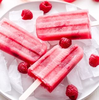 Raspberry Rosé Popsicles are the perfect summer treat for all the rosé lovers! These boozy wine popsicles will cool you off on a hot day and are sure to be a hit at your next party! #popsicles #rosé #raspberries #dessert