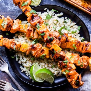 Sweet and Spicy Grilled Chicken and Pineapple Skewers will be your go-to dinner all summer long! Flavored with chili garlic sauce and sweetened with honey, these paleo and gluten-free chicken skewers are perfect for a protein packed, healthy dinner! #chicken #pineapple #skewers #paleo #glutenfree #healthydinner #grilledchicken