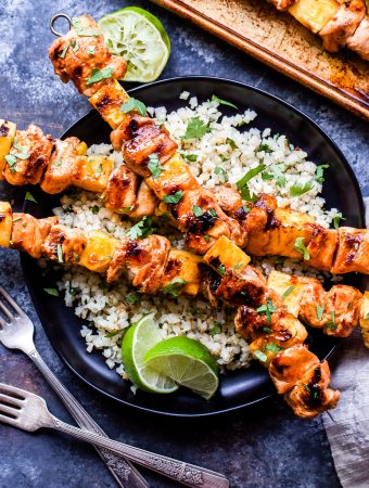 Sweet and Spicy Grilled Chicken and Pineapple Skewers will be your go-to dinner all summer long! Flavored with chili garlic sauce and sweetened with honey, these paleo and gluten-free chicken skewers are perfect for a protein packed, healthy dinner! #chicken #pineapple #skewers #paleo #glutenfree #healthydinner #grilledchicken