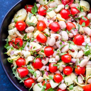 This White Bean, Artichoke and Tomato Salad is a light and healthy salad that's perfect for summer! Dressed in a simple lemon vinaigrette and full of fresh herbs, it's a great side dish to go with your favorite grilled protein! #salad #vegan #beans #tomatoes #lemon #sidedish #glutenfree