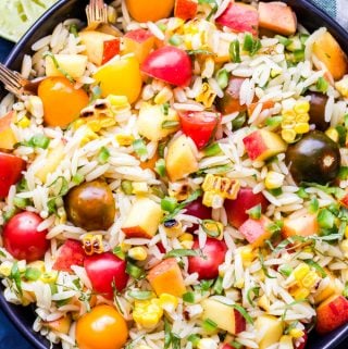 Summer Vegetable Orzo Salad is full of summer's best produce! Tomatoes, corn, peaches, basil and orzo all tossed together in a honey lime dressing. A light and healthy pasta salad you'll love! #salad #orzo #tomatoes #peaches #vegan #healthyrecipe