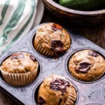 Chocolate Chunk Zucchini Muffins are the perfect way to use extra zucchini from your garden. Almond butter replaces the oil in these muffins and they're packed with shredded zucchini and dark chocolate chunks. A delicious way to start the morning! #muffins #zucchini #zucchinimuffins #chocolate #breakfast #almondbutter #brunch