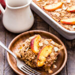 Cinnamon Peach Almond Baked Oatmeal is perfect for the weekends and great reheated for a quick and easy breakfast during the week! Loaded with sweet peaches, plenty of cinnamon and toasted almonds for crunch. A creamy, healthy and delicious alternative to traditional oatmeal! #oatmeal #bakedoatmeal #peach #breakfast #glutenfree #healthybreakfast