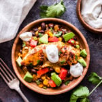 Skillet Enchilada Chicken with Black Beans and Corn is a quick and easy Mexican dinner that will be on your table in 30 minutes! All the flavor of traditional chicken enchiladas without all the work! #enchiladas #chicken #skillet #easyrecipe #glutenfree #easydinner