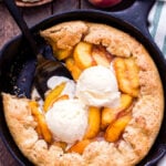 Skillet Peach Cobbler is the ultimate summer treat! A simple biscuit crust topped with fresh, sweet peaches and all baked in a cast iron skillet. Top with vanilla ice cream for the perfect bite! #peaches #peachcobbler #skillet #dessert
