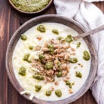 This Creamy Italian Cauliflower Soup is so thick and delicious that you'll forget you're eating soup. A low-carb alternative to potato soup, but just as satisfying thanks to the Italian sausage, pesto and Fontina cheese piled on top! #cauliflower #soup #cauliflowersoup #lowcarb #italian #glutenfree