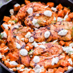 Harissa Chicken, Sweet Potato and Chickpea Skillet is a simple, satisfying and super flavorful dinner perfect for busy nights. Spicy from the harissa sauce, but balanced out by the sweet potatoes and cool, creamy, herb yogurt sauce. #harissa #chicken #sweetpotato #chickpeas #skilletrecipe #easydinner