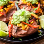 Baked sweet potatoes are topped with mushrooms, peppers and onions in a flavorful blend of Mexican spices. Topped with guacamole.