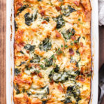 This Spinach, Bacon and Cheese Strata will be a fantastic addition to your next holiday brunch or weekend breakfast! Make it the night before and bake it in the morning for a stress free, hearty egg dish everyone will enjoy! #strata #eggs #bacon #spinach #bread #brunch #breakfast #christmas #thanksgiving #breakfastcasserole