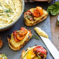 Basil Pesto Hummus and Roasted Tomato Crostini