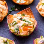 Baked Buffalo Chicken Wonton Cups are the perfect portable appetizer to serve for game day or your next party! You'll never suspect that the spicy, creamy, cheesy chicken filling was made with lighter ingredients! #buffalochicken #gameday #appetizer #superbowl #wontoncups #chicken