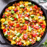 This Southwest Turkey and Egg Breakfast Skillet is a delicious and filling way to start your day! Southwest seasoned ground turkey and scrambled eggs are topped with cheese, tomatoes, avocado, cilantro and salsa. It's perfect for meal prep, a weekend breakfast or even dinner! #breakfastskillet #scrambledeggs #groundturkey #lowcarb #glutenfree #mexicanfood #skillet